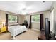 Bedroom featuring neutral colors, natural light, decorative lamps, and dark accent curtains at 400 Sw 35Th St, Ocala, FL 34471