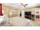 Bedroom featuring neutral colors, natural light, ceiling fan, and access to an en-suite bathroom at 400 Sw 35Th St, Ocala, FL 34471