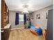 Spacious bedroom with a ceiling fan, natural light, and laminate wood-look floors at 400 Sw 35Th St, Ocala, FL 34471