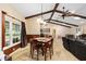 Open-concept dining area with exposed beams, seamlessly connecting to the kitchen and living space at 400 Sw 35Th St, Ocala, FL 34471
