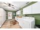 Functional laundry area featuring tiled floors, white washer and dryer, and lots of storage cabinets at 400 Sw 35Th St, Ocala, FL 34471