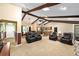 Spacious living area with wood beam ceilings seamlessly connects to the kitchen, creating an open and inviting living space at 400 Sw 35Th St, Ocala, FL 34471