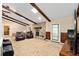 Living room featuring exposed beams, a stone fireplace, and a sliding glass door for natural light at 400 Sw 35Th St, Ocala, FL 34471