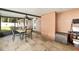 Covered porch with tiled flooring and outdoor dining table; perfect for entertaining or relaxing at 400 Sw 35Th St, Ocala, FL 34471