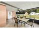 Covered porch with tiled flooring, an outdoor dining set, and a view of the backyard at 400 Sw 35Th St, Ocala, FL 34471