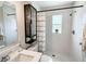Modern bathroom featuring a glass-enclosed shower, black hardware, and a stylish vanity at 412 Sunny Ct, Fruitland Park, FL 34731