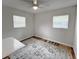 Another angle on the bedroom with neutral walls and wood floors and sunny windows at 412 Sunny Ct, Fruitland Park, FL 34731