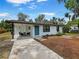 Charming home with white exterior and blue door at 412 Sunny Ct, Fruitland Park, FL 34731
