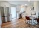 Bright kitchen features stainless steel appliances, white cabinets, and a breakfast bar with seating at 412 Sunny Ct, Fruitland Park, FL 34731