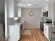 The kitchen features white cabinets, stainless steel appliances, and an open design to the living area at 412 Sunny Ct, Fruitland Park, FL 34731