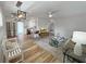 Inviting living room with hardwood floors and open concept to the kitchen and stylish modern decor at 412 Sunny Ct, Fruitland Park, FL 34731