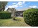 Outdoor patio with barbecue grill and seating surrounded by manicured landscaping at 419 Aldama Ave, The Villages, FL 32159