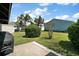 Landscaped backyard with a well-manicured lawn and mature trees at 419 Aldama Ave, The Villages, FL 32159