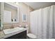 Bathroom with a single sink, granite countertops, and a shower with a patterned curtain at 419 Aldama Ave, The Villages, FL 32159
