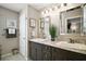 Bright bathroom featuring double sinks with granite countertops and modern lighting fixtures at 419 Aldama Ave, The Villages, FL 32159