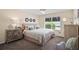 Bright bedroom with ceiling fan, featuring stylish furniture, window view and neutral tones at 419 Aldama Ave, The Villages, FL 32159