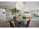 Contemporary dining room with a glass-top table, stylish chairs, and lots of natural light at 419 Aldama Ave, The Villages, FL 32159