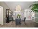 Stylish dining area with a modern light fixture, glass-top table, and views into other living spaces at 419 Aldama Ave, The Villages, FL 32159