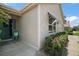 Exterior view of home showcasing the front door, garage, and well-maintained landscaping at 419 Aldama Ave, The Villages, FL 32159