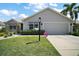 Charming single-story home featuring a well-manicured lawn and a two-car garage at 419 Aldama Ave, The Villages, FL 32159