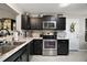 Well-equipped kitchen with granite countertops, stainless appliances, and ample cabinet storage at 419 Aldama Ave, The Villages, FL 32159