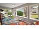 Bright sunroom featuring large windows overlooking the yard and colorful decor at 419 Aldama Ave, The Villages, FL 32159