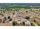 Aerial shot capturing a mix of fields, houses, and barns surrounded by mature trees at 4635 Brantley Rd, Groveland, FL 34736