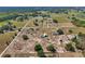 Aerial view showcasing land with multiple houses, barns, and outbuildings, perfect for a farm at 4635 Brantley Rd, Groveland, FL 34736