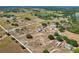 Expansive aerial view of a large lot surrounded by trees, fields, and other homes at 4635 Brantley Rd, Groveland, FL 34736