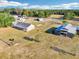 Aerial view of the property featuring a home, barn, and expansive green pasture at 4635 Brantley Rd, Groveland, FL 34736