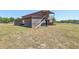 Rustic barn with open-air structure and outdoor seating area at 4635 Brantley Rd, Groveland, FL 34736