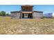 Rustic barn with open lower level, stairs, and adjacent trailer at 4635 Brantley Rd, Groveland, FL 34736