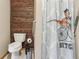 Unique bathroom features a modern toilet and shower area with a novelty dinosaur shower curtain at 4635 Brantley Rd, Groveland, FL 34736