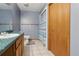 Bathroom showcasing a vanity with modern fixtures, toilet, and a shower with a decorative curtain at 4635 Brantley Rd, Groveland, FL 34736