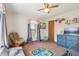 Cozy bedroom with natural light, cute decor, and a rocking chair, creating a warm atmosphere at 4635 Brantley Rd, Groveland, FL 34736