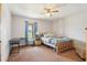 Bedroom featuring natural light, ceiling fan, desk, and a cozy bed at 4635 Brantley Rd, Groveland, FL 34736