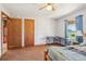 Bedroom featuring natural light, two closets, ceiling fan, desk, and a cozy bed at 4635 Brantley Rd, Groveland, FL 34736