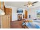 Bedroom with a TV, wooden dresser, and natural light offering a comfortable and relaxing atmosphere at 4635 Brantley Rd, Groveland, FL 34736