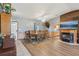 Cozy dining room features wood floors, fireplace, and large dining table with seating for eight at 4635 Brantley Rd, Groveland, FL 34736