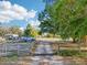 Long dirt driveway leading to a house surrounded by mature trees under a sunny sky at 4635 Brantley Rd, Groveland, FL 34736