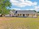 Charming single-story home with a covered front porch and a well-maintained lawn at 4635 Brantley Rd, Groveland, FL 34736