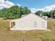 Side view of a single-story home featuring a neutral color, simple design, and a small porch at 4635 Brantley Rd, Groveland, FL 34736