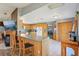 Bright kitchen with light wood cabinets, a breakfast bar, and tile flooring at 4635 Brantley Rd, Groveland, FL 34736