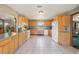 Spacious kitchen features ample cabinetry, white appliances, and tile flooring at 4635 Brantley Rd, Groveland, FL 34736