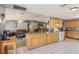 Open kitchen with an island, a breakfast bar, and views of the living area at 4635 Brantley Rd, Groveland, FL 34736