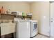 Functional laundry room with a utility sink, shelving, and washer and dryer at 4635 Brantley Rd, Groveland, FL 34736