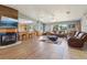 Open-concept living space with a fireplace, hardwood floors, and ample seating, perfect for entertaining at 4635 Brantley Rd, Groveland, FL 34736
