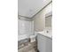 Bathroom featuring white tub and shower, white toilet, and white vanity at 48 Oakridge Dr, Frostproof, FL 33843