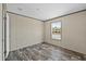 Bedroom featuring natural light from the window and wood-look floors at 48 Oakridge Dr, Frostproof, FL 33843