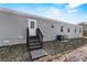 Exterior featuring siding, windows, back door, and stairs at 48 Oakridge Dr, Frostproof, FL 33843